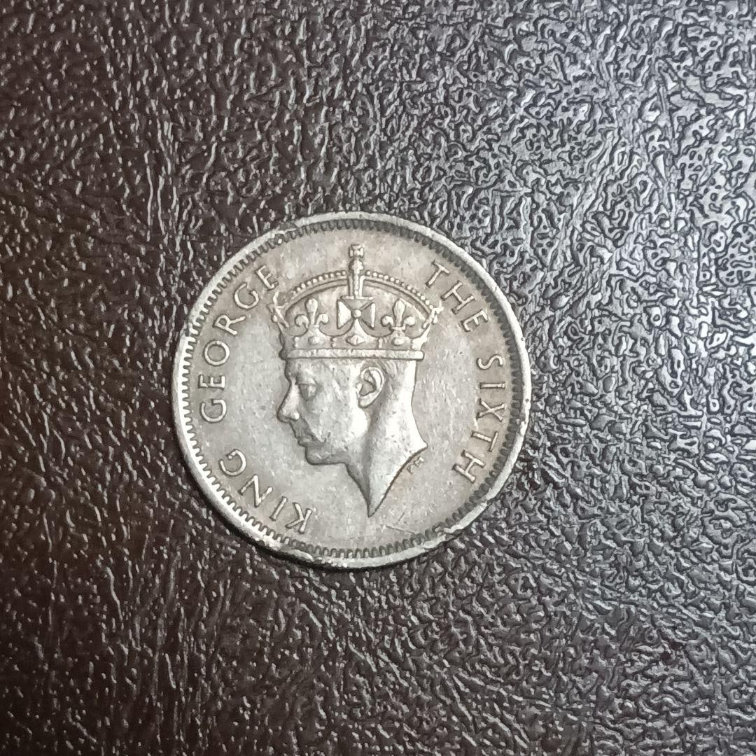 1950 George VI 10 Cents Coin: A 10-cent coin issued in 1950, featuring the portrait of King George VI. Country: Malaysia Denomination: 10 cents Year of Issue: 1950 Design: Portrait of King George VI Design: Emblem of the issuing m