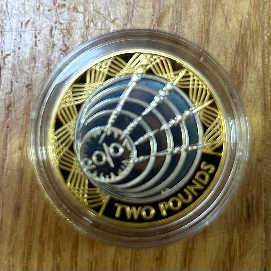 Two-pound coin with spider web pattern (1 of 6)