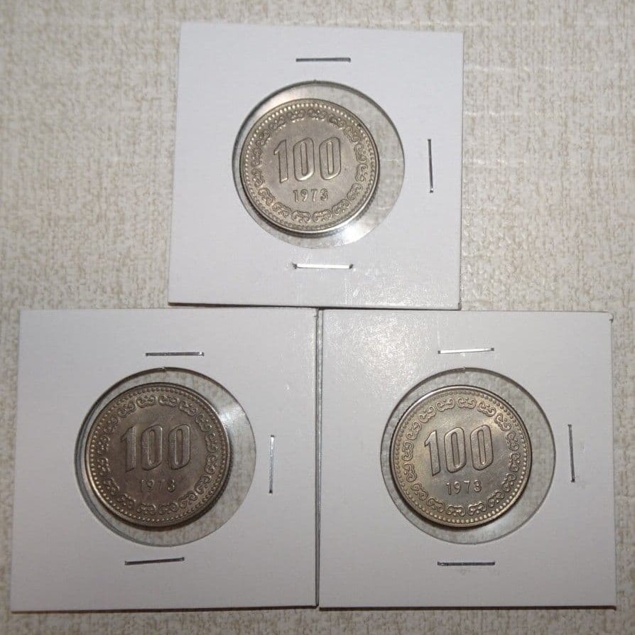 Three old 100 Korean Won coins issued in 1973 by South Korea. (1 of 2)