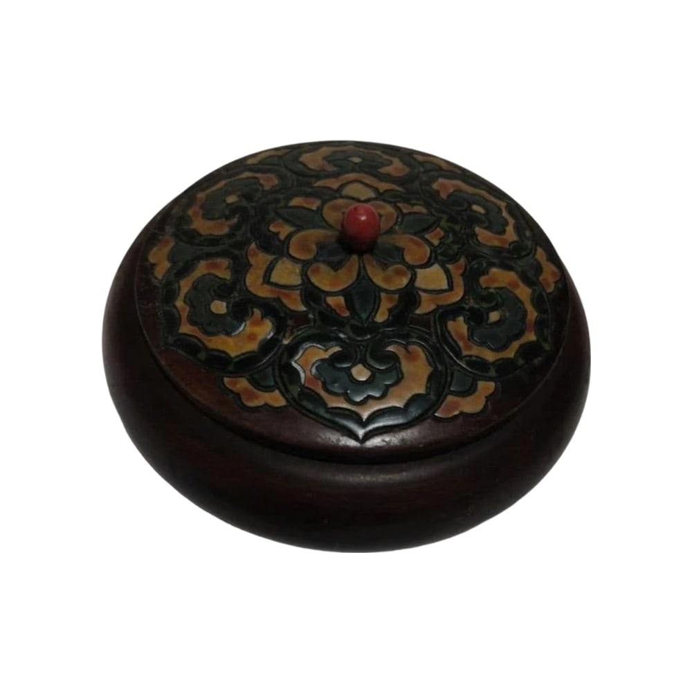 Wooden incense box with floral motifs: A wooden incense box, adorned with floral carvings, predominantly in dark brown with multicolored embellishments. Design: Lidded incense box, carved with floral motifs. Material: Wood, interior coated