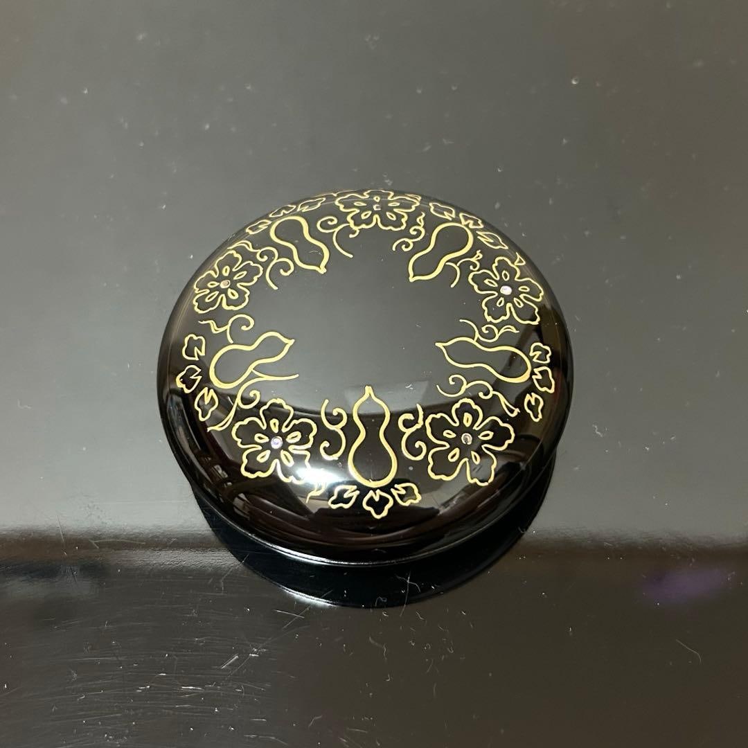 This is a flat, circular incense box. - 3