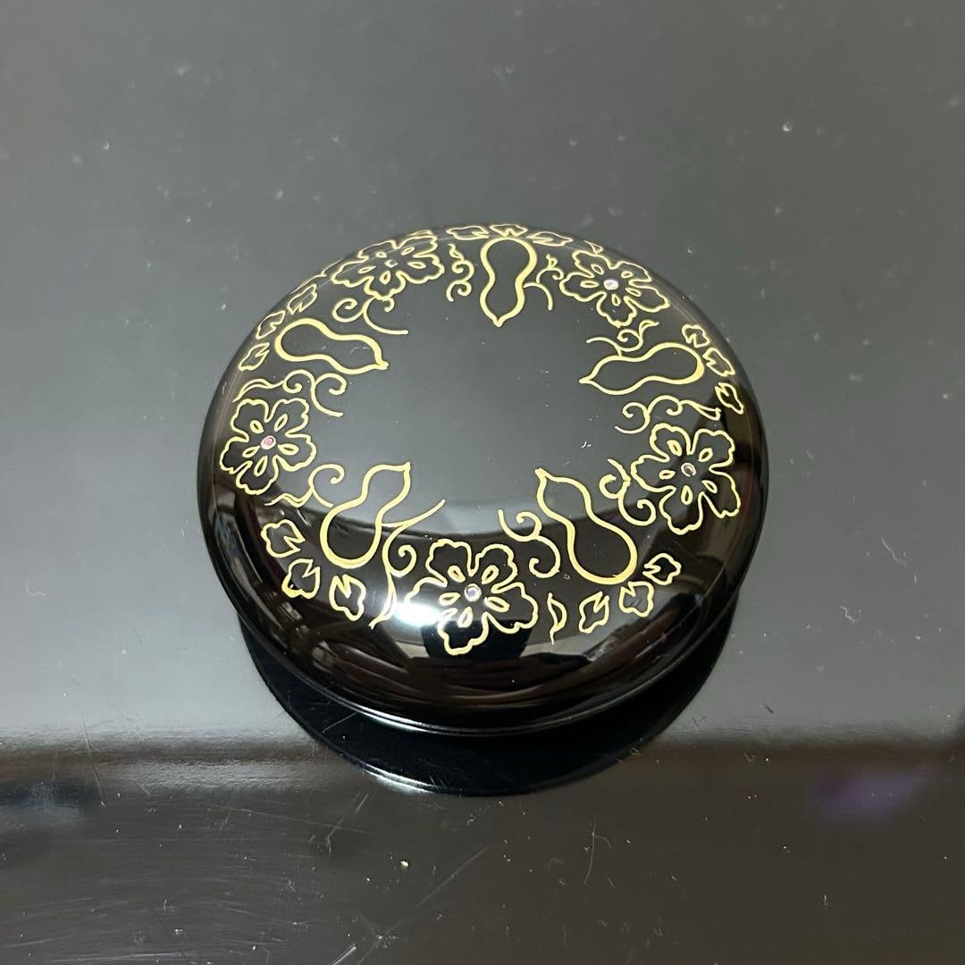 This is a flat, circular incense box. - 4