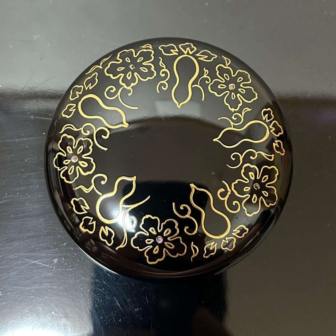 This is a flat, circular incense box. - 5