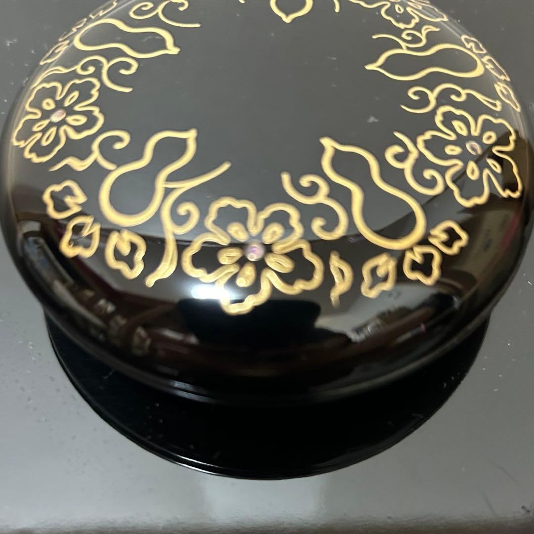 This is a flat, circular incense box. - 6