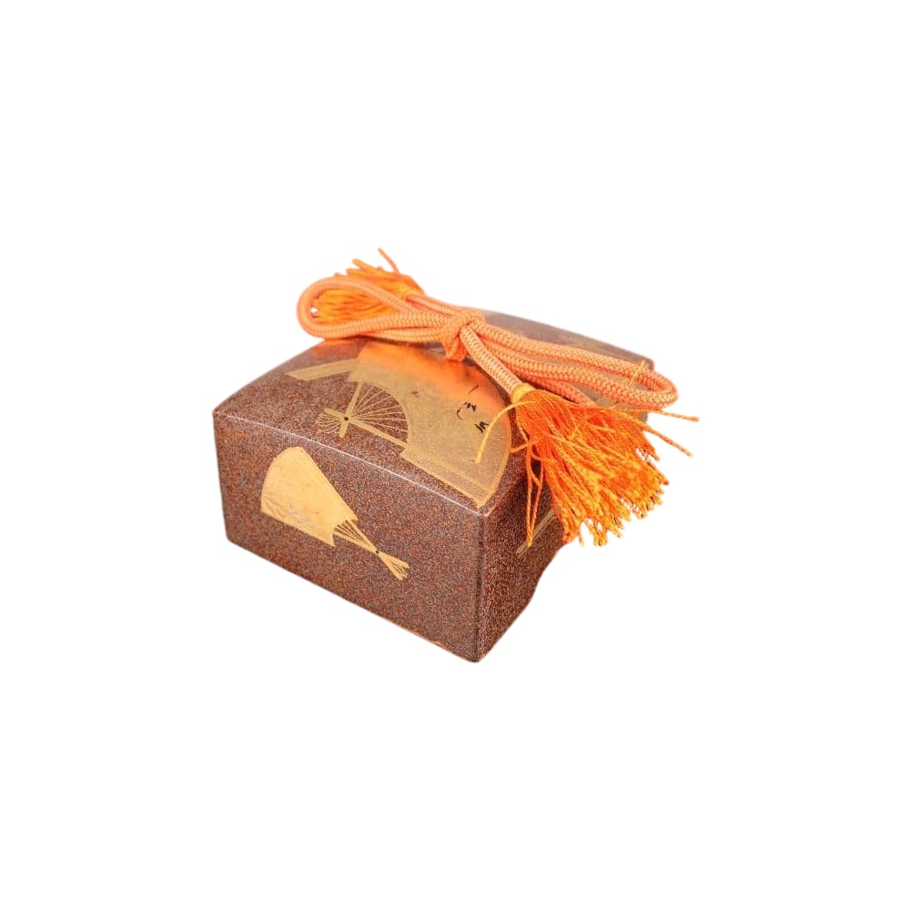 A brown incense box, adorned with a gold fan-shaped motif.: A brown incense box, adorned with a gold fan-shaped pattern. Color: Brown Decoration: Gold pattern on the fan surface Cord Color: Orange Shape: Rectangular Function: Incense box (a box for holding inc