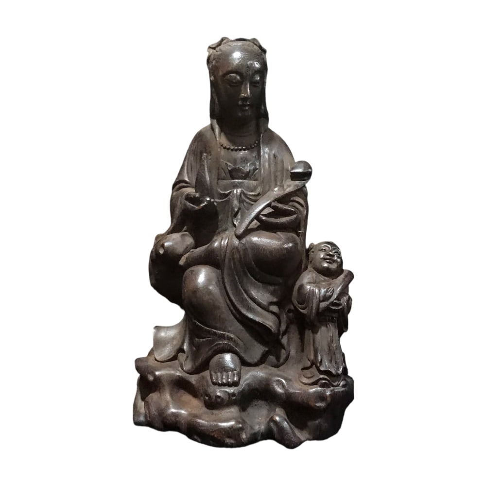Qing Dynasty Old Agarwood Ruyi Guanyin Statue: This Qing Dynasty old agarwood Ruyi Guanyin statue is carved from precious old agarwood, featuring clear grain. The Guanyin's face is full, with slightly open eyes, orderly layered clothing, graceful