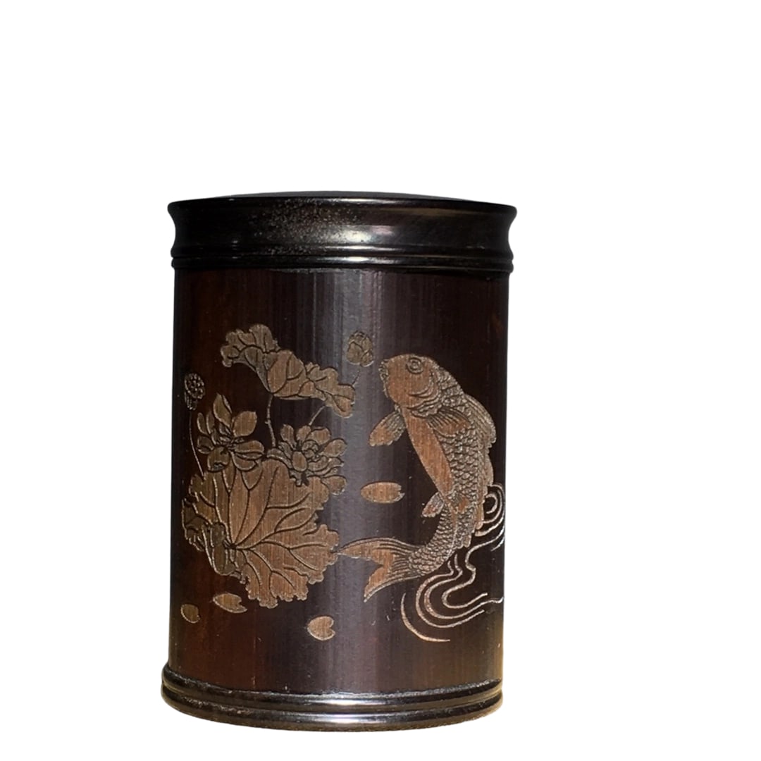 Old Plum Bamboo Hand-carved Tea Caddy: This tea caddy features plum and bamboo motifs, showcasing exquisite hand-carving craftsmanship with a rich patina that reflects the passage of time. The intricate carving and natural texture compleme