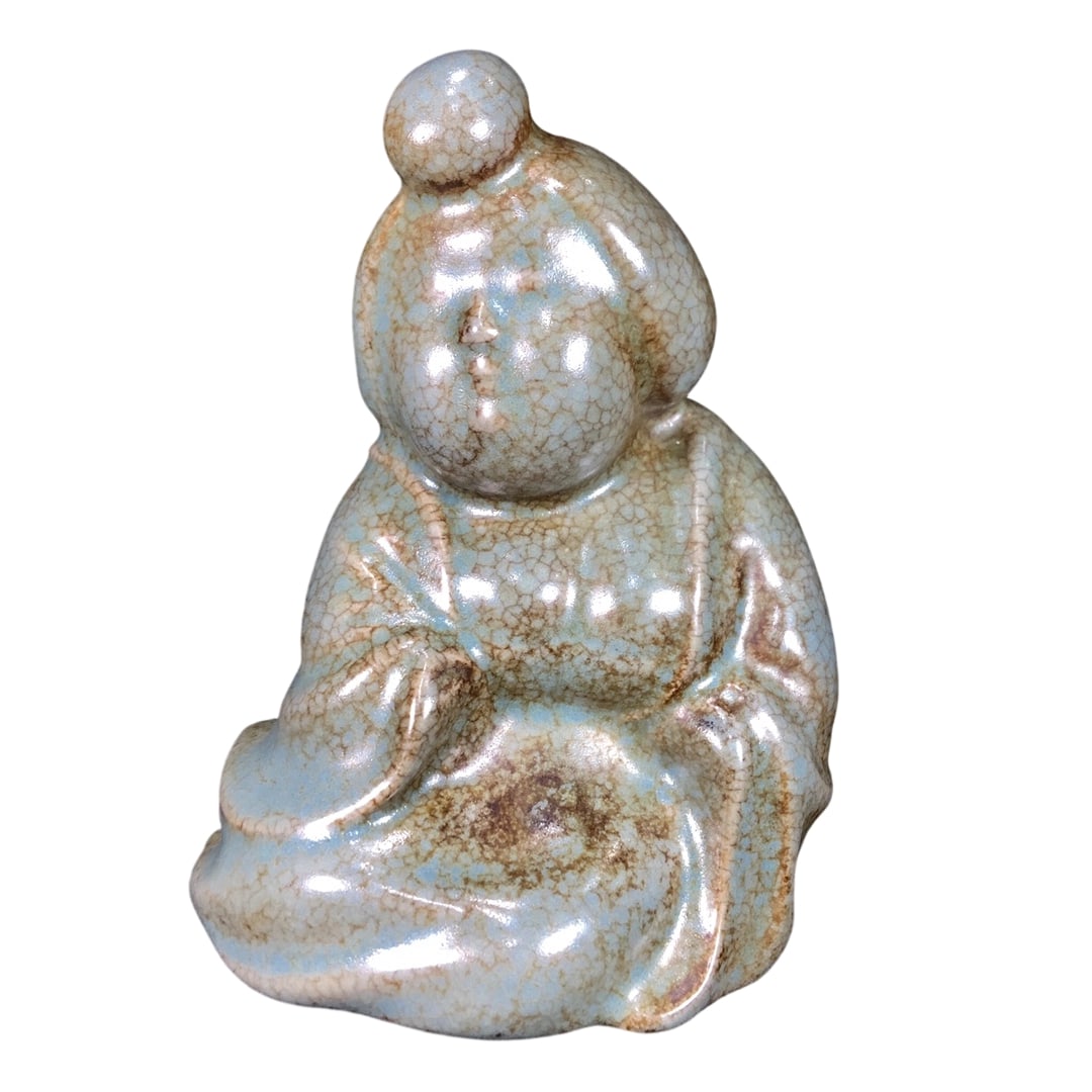 Song Dynasty Ru Ware Lady Figurine: This Song Dynasty Ru ware lady figurine features an elegant celadon glaze with natural patina, showcasing the charm of antiquity. Its vivid form and flowing lines reflect the exquisite craftsmanship