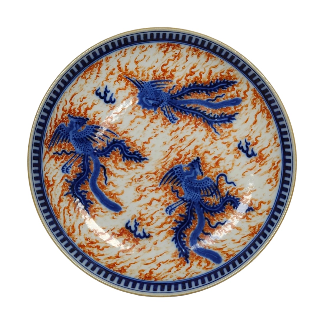 Qing Xianfeng Period Underglaze Red and Blue Phoenix Plate: This underglaze red and blue phoenix plate from the Qing Xianfeng period exemplifies the exceptional craftsmanship and artistic beauty of Qing dynasty ceramics. The phoenix motif on the plate