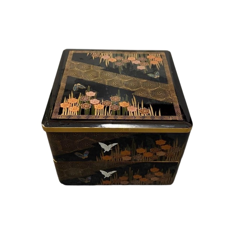 Two-tiered Jubako Box, Raden Inlay, Butterfly and Floral Motif, Lacquerware: A two-tiered lacquered jubako box adorned with mother-of-pearl inlay depicting butterflies and intricate floral patterns.Form: Two-tiered jubako box Decorative Techniques: Mother-of-pearl inlay, maki-