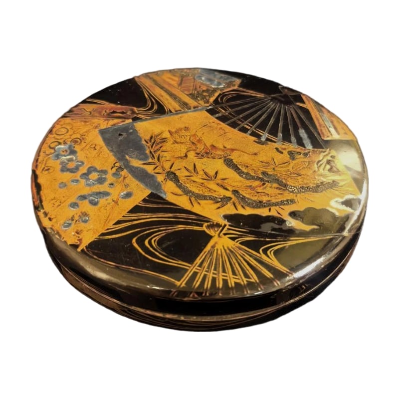 A Showa Period Maki-e Lacquer Incense Box, Fan-Shaped Design, Gold Maki-e, Black Lacquer, With: This incense box is a traditional Japanese maki-e lacquerware.The incense box is exquisitely crafted with a black lacquer base, adorned with elegant gold maki-e fan motifs, pine and bamboo designs, an