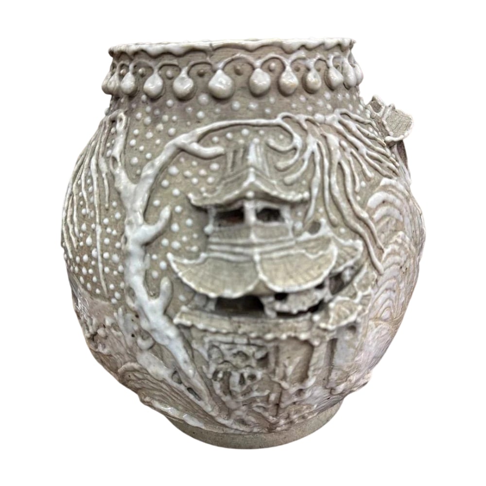 Late Qing Dynasty, China: White Porcelain Teapot with Pearl Ground, Relief Decoration, and Pierced: A ceramic vase with unique carving and textural charm.Traditional Relief and Openwork Carving Techniques: The surface features three-dimensional reliefs of pavilions and landscape patterns, all