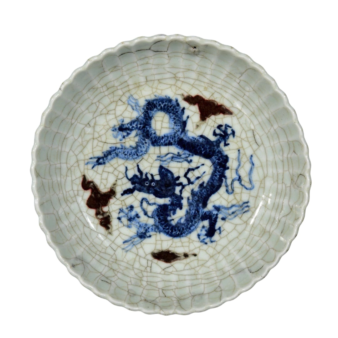 Ming Dynasty Blue and Red Glazed Crackle Dragon Plate: This plate is a blue and red glazed piece from the Xuande period of the Ming Dynasty. The crackle glaze is natural, and the dragon motif is vivid and lifelike, showcasing the exquisite craftsmanship
