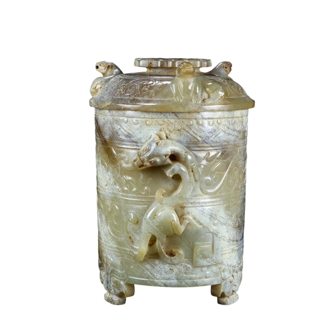 Hetian Jade Cup with Auspicious Beast Pattern: This Hetian jade cup features a finely detailed carving of auspicious beast patterns. The jade is of exquisite quality, and the piece is in perfect condition. The presence of soil marks adds a strong