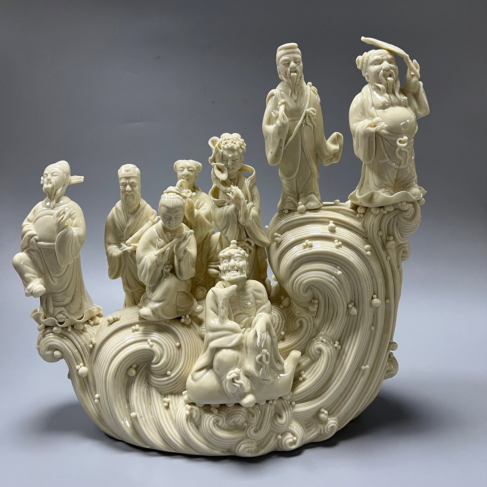 Dehua white porcelain Eight Immortals Crossing the Sea: This piece is exquisitely crafted using traditional Dehua hand-sculpting techniques. Measuring 32x33 cm, the sculpture depicts the Chinese folktale "The Eight Immortals Crossing the Sea, Each Displayi