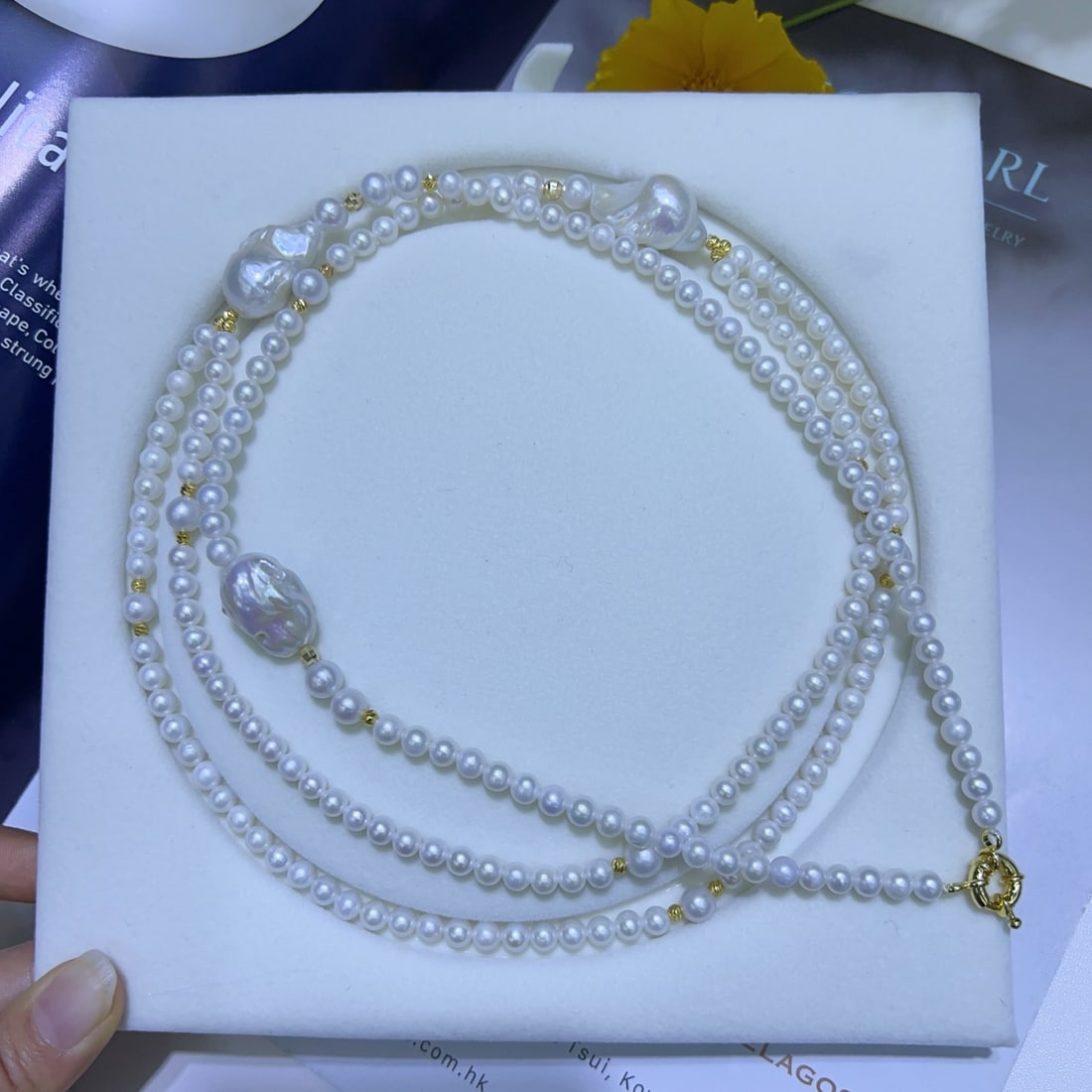 Natural Freshwater Pearl Long Necklace: This natural freshwater pearl long necklace features an elegant double-layer design with baroque accents, showcasing its unique charm. The pearls' gentle luster and minimal blemishes complement each o