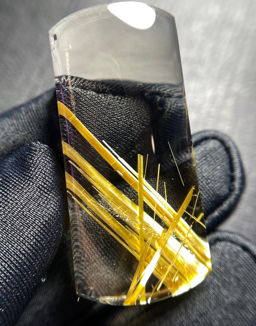 Natural Rutilated Quartz Pendant: This pendant is crafted from natural rutilated quartz, showcasing a golden luster with orderly thick rutile threads. The white body rutilated quartz shimmers brilliantly under light, truly captivating