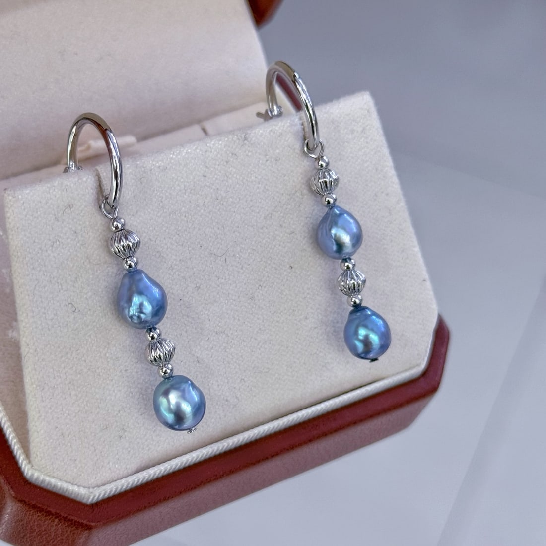 Natural Baroque Pearl Earrings: These earrings feature natural baroque pearls from the sea, with an extremely high luster and a captivating Yuji Blue aurora color. The pearls measure approximately 6-7mm, showcasing a unique natural 