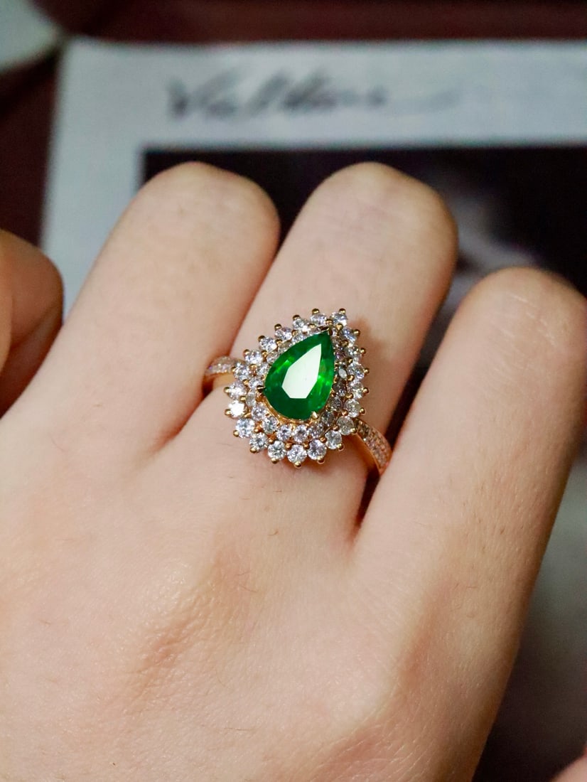 18K Gold Natural Emerald Ring: This ring is meticulously crafted in 18K gold, set with a high-quality emerald that exudes an elegant and beautiful aura. The diamond accents add a touch of luxury, making it a collectible piece of