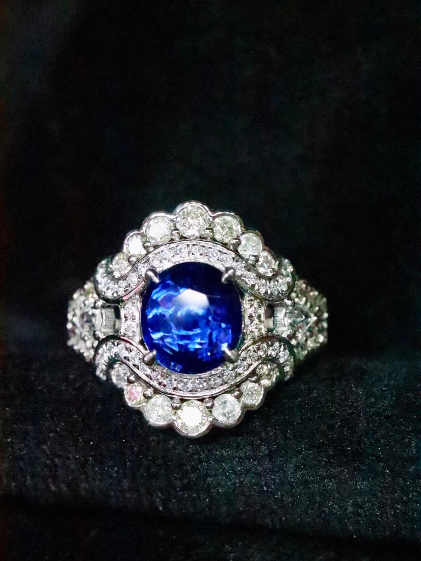Platinum Natural Sapphire Ring: This ring captivates with its rich blue sapphire and impeccable quality. The main stone is a flawless glassy sapphire, complemented by luxuriously set high-quality diamonds, showcasing unparalleled