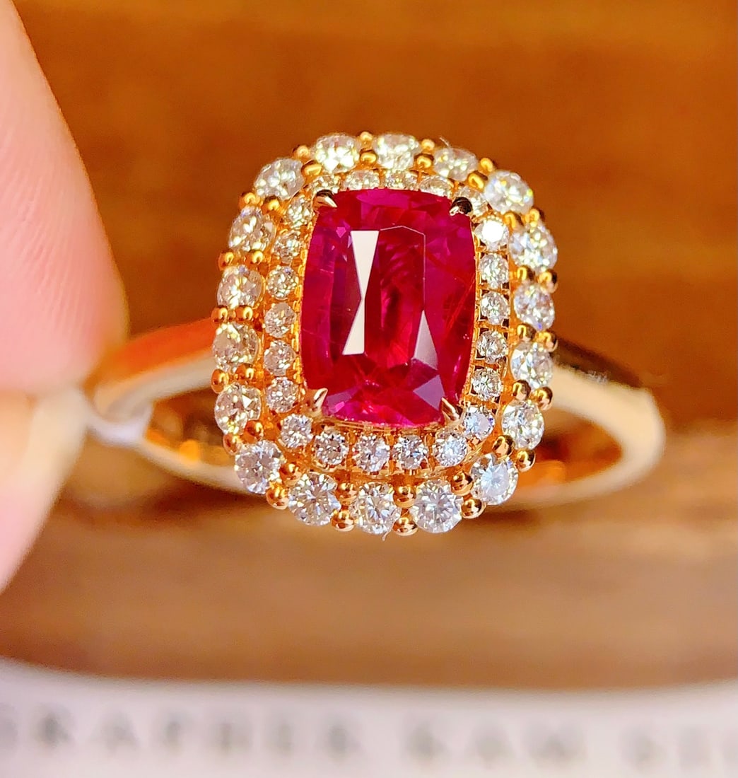 18K Gold Natural Unheated Ruby Ring: This ring is meticulously crafted in 18K gold, featuring a natural unheated ruby that exudes an aura of elegance and nobility. The surrounding diamonds add a brilliant sparkle, perfectly embodying