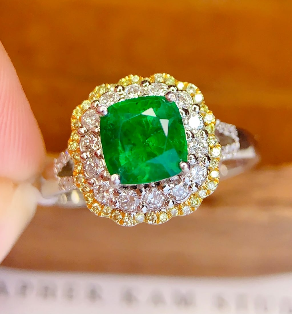 18K Gold Natural Emerald Ring: This ring is meticulously crafted in 18K gold, featuring a natural emerald that exudes a captivating brilliance. Surrounded by 70 diamonds, it adds a touch of luxury. Wearing this ring showcases