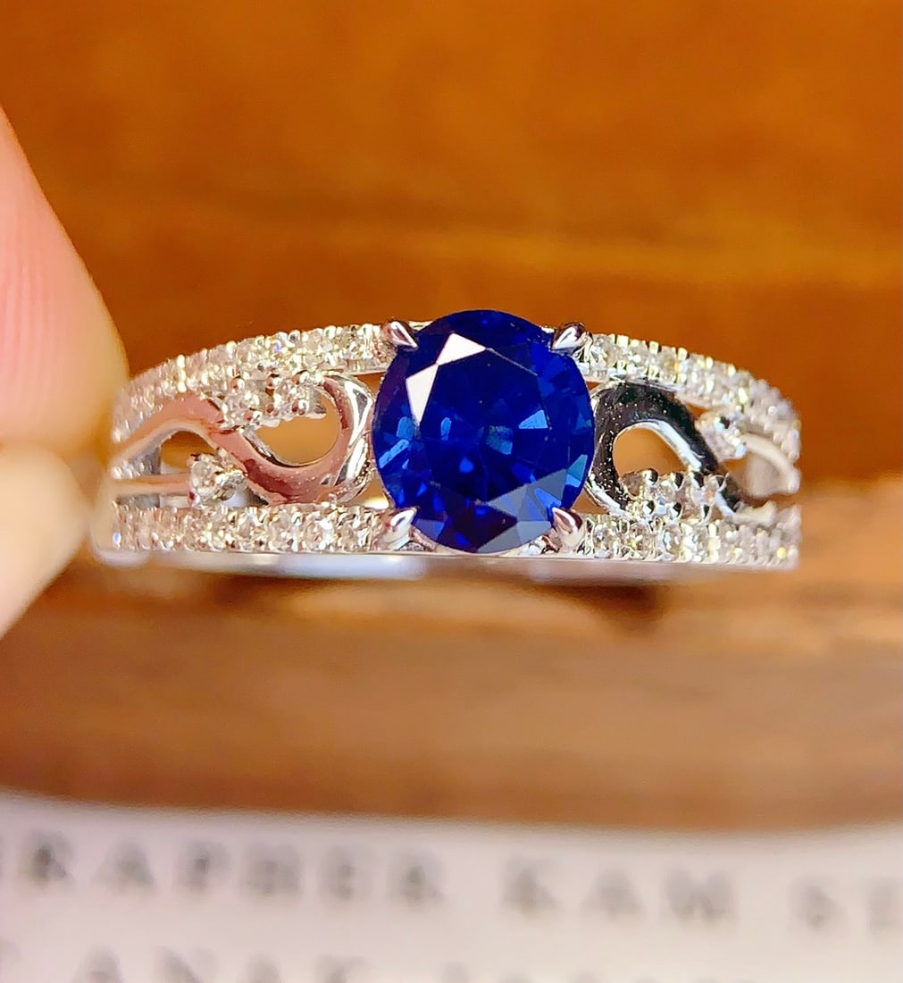 18K Gold Natural Sapphire Ring: This ring features an 18K gold base set with a natural sapphire, exuding an aura of elegance and nobility. The deep hue of the sapphire complements the brilliance of 46 diamonds, creating a perfect