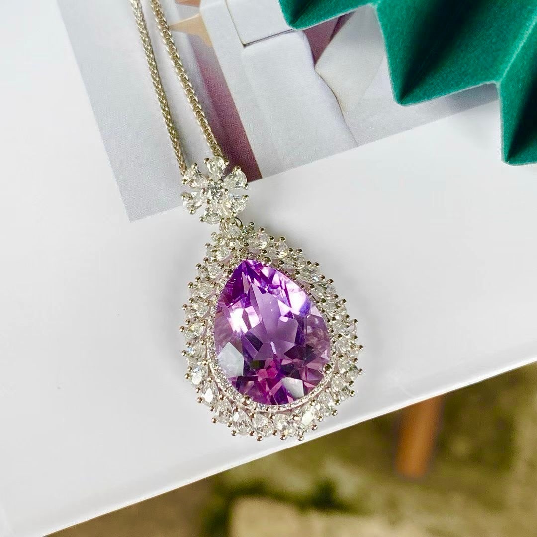 Amethyst Pendant: Teardrop-shaped amethyst pendant set in 925 silver, surrounded by accent stones like starlight, gently adorning the neck with romance and brilliance. (Main stone 12*16mm)