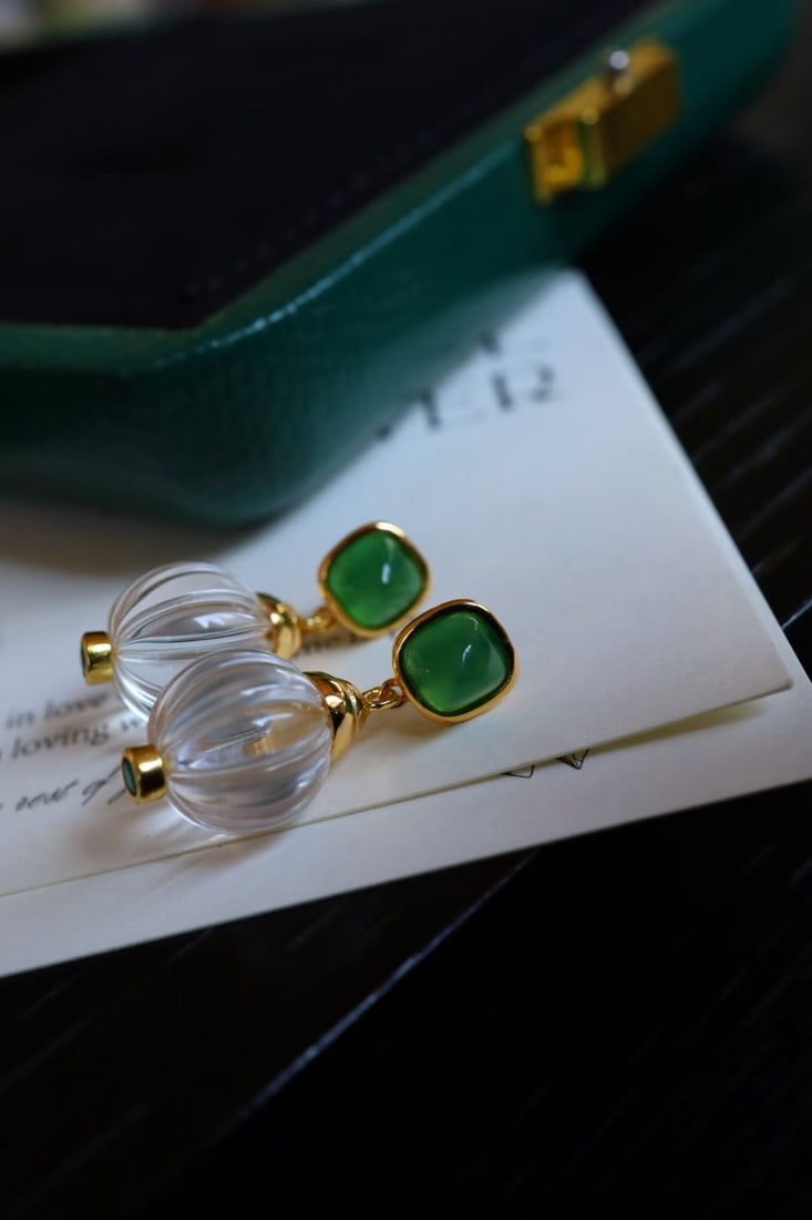 Natural White Crystal and Green Chalcedony Earrings: These earrings feature natural white crystal and green chalcedony as the main stones, showcasing a refreshing design. The flawless and transparent gemstones complement the silver material, exuding