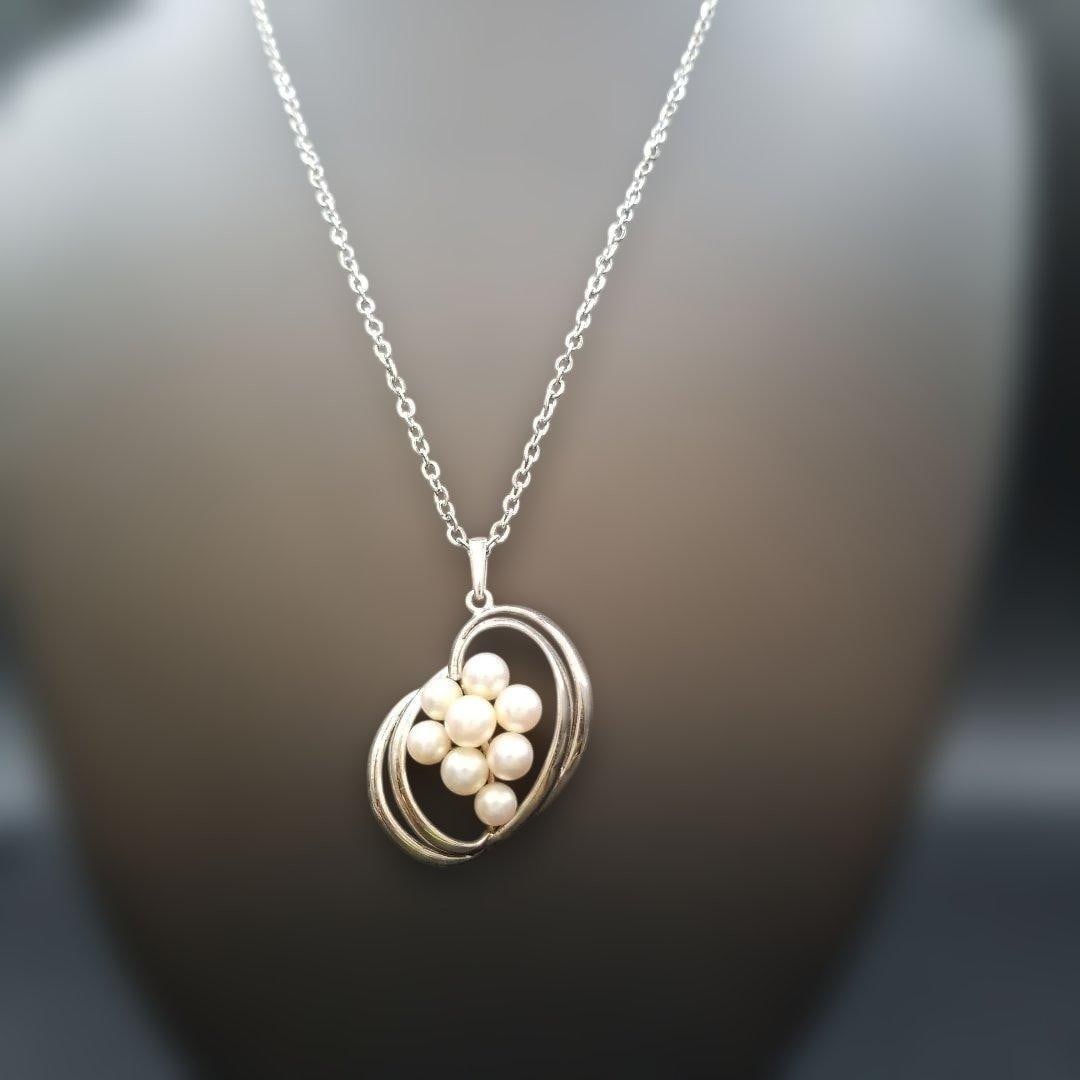 Second-hand - Mikimoto Grape Design Pearl Necklace with 8 pearls: Mikimoto Necklace Color: Silver Design: Grape pattern / Silver chain Back of pendant engraved with MS (Mikimoto) Non-original chain: Made of stainless steel Product Condition Being a second-hand item,