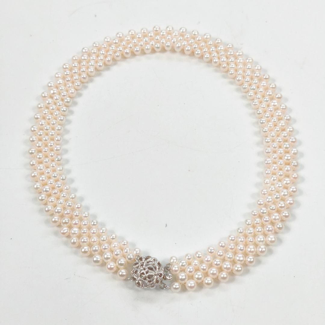 Second-hand - Natural Pearl Necklace: This is a triple-strand pearl necklace featuring exquisite woven design and emitting an elegant luster. Material: Pearls Number of strands: Three Clasp design: Hollow-carved decoration Product Overvie