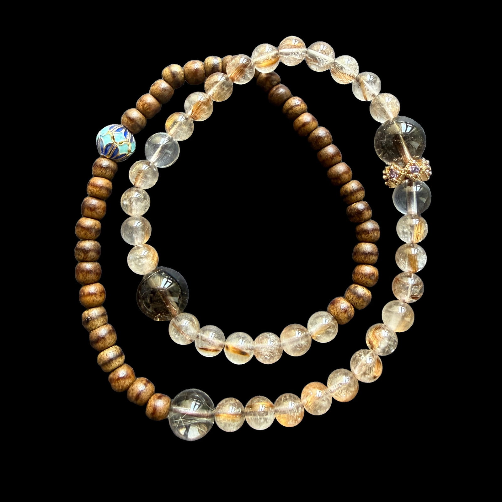 Natural Rutilated Quartz and Agarwood Beaded Bracelet with Wood Beads, Approx. 16g Estate Jewelry: A beaded bracelet featuring natural rutilated quartz beads paired with agarwood and wood beads, accented with decorative spacer beads. The bracelet offers an attractive contrast between the warm natur