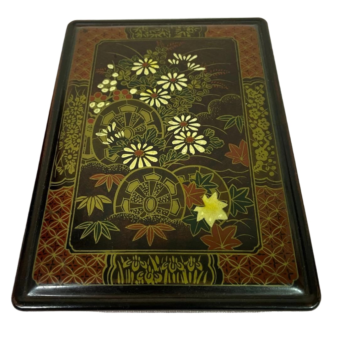 Inkstone Box with Imperial Carriage, Chrysanthemum, and Red Maple Lacquer Style Calligraphy Tools: This is a beautiful inkstone box depicting traditional imperial carriage (Genji-guruma), along with chrysanthemums and autumn leaves. The interior is equipped with compartments for storing an