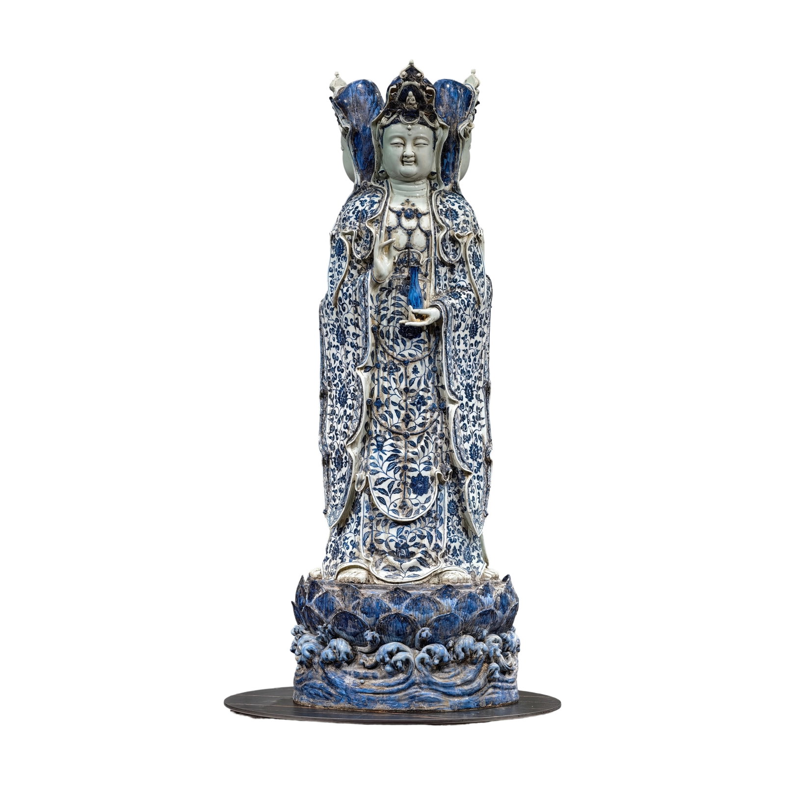 Ming Dynasty Blue and White Lotus Pattern Three-faced Guanyin Statue: A large-scale, Ming Dynasty Xuande period blue-and-white porcelain sculpture of a three-faced Guanyin (Avalokitesvara) depicting a lotus scroll pattern. (Height 132 cm, Width 50 cm) The Guanyin statue