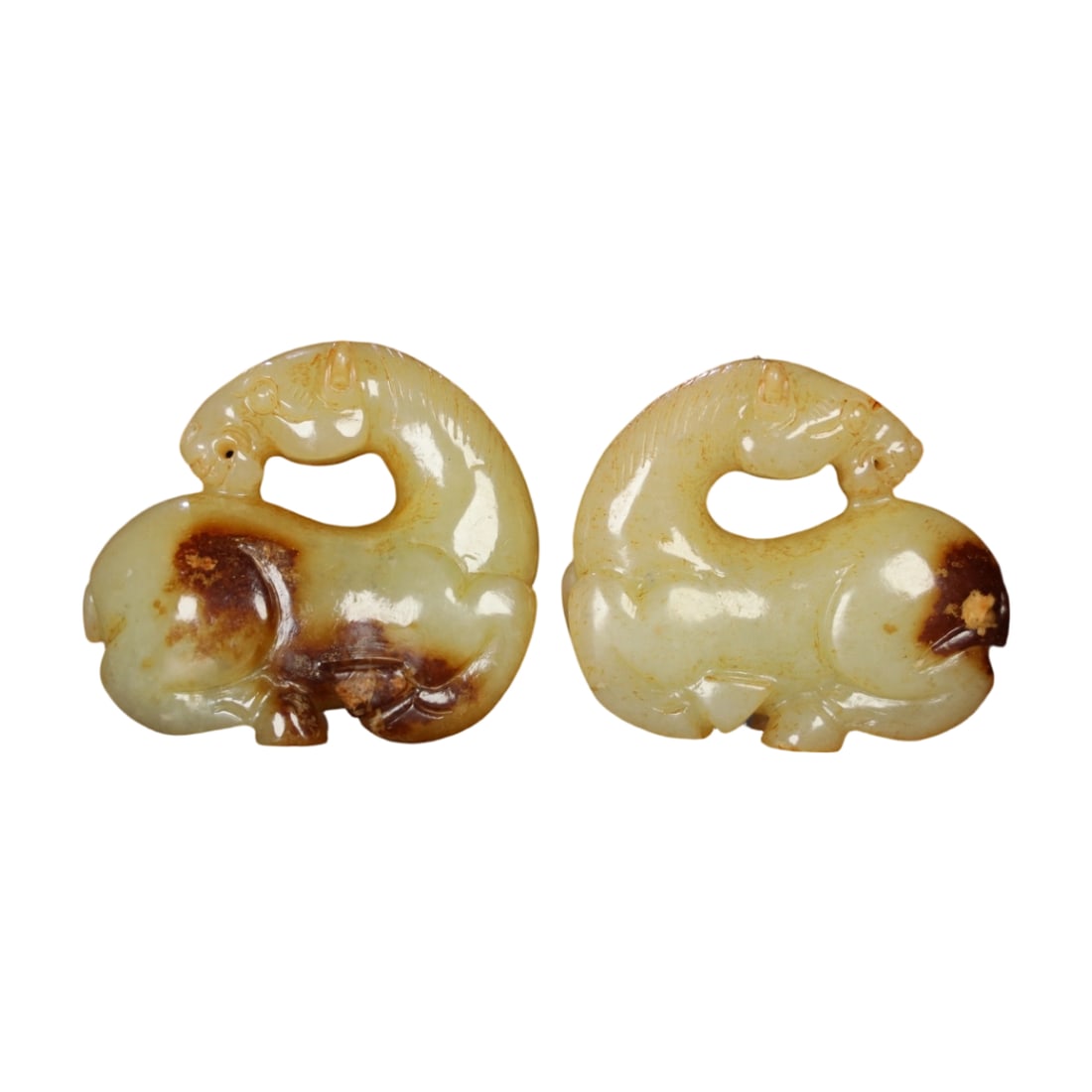 Hetian Jade Horse: This Hetian jade horse features fine and smooth jade quality with an aged patina, showcasing exquisite carving skills. Its vivid form and well-executed details reflect a high level of craftsmanship. (