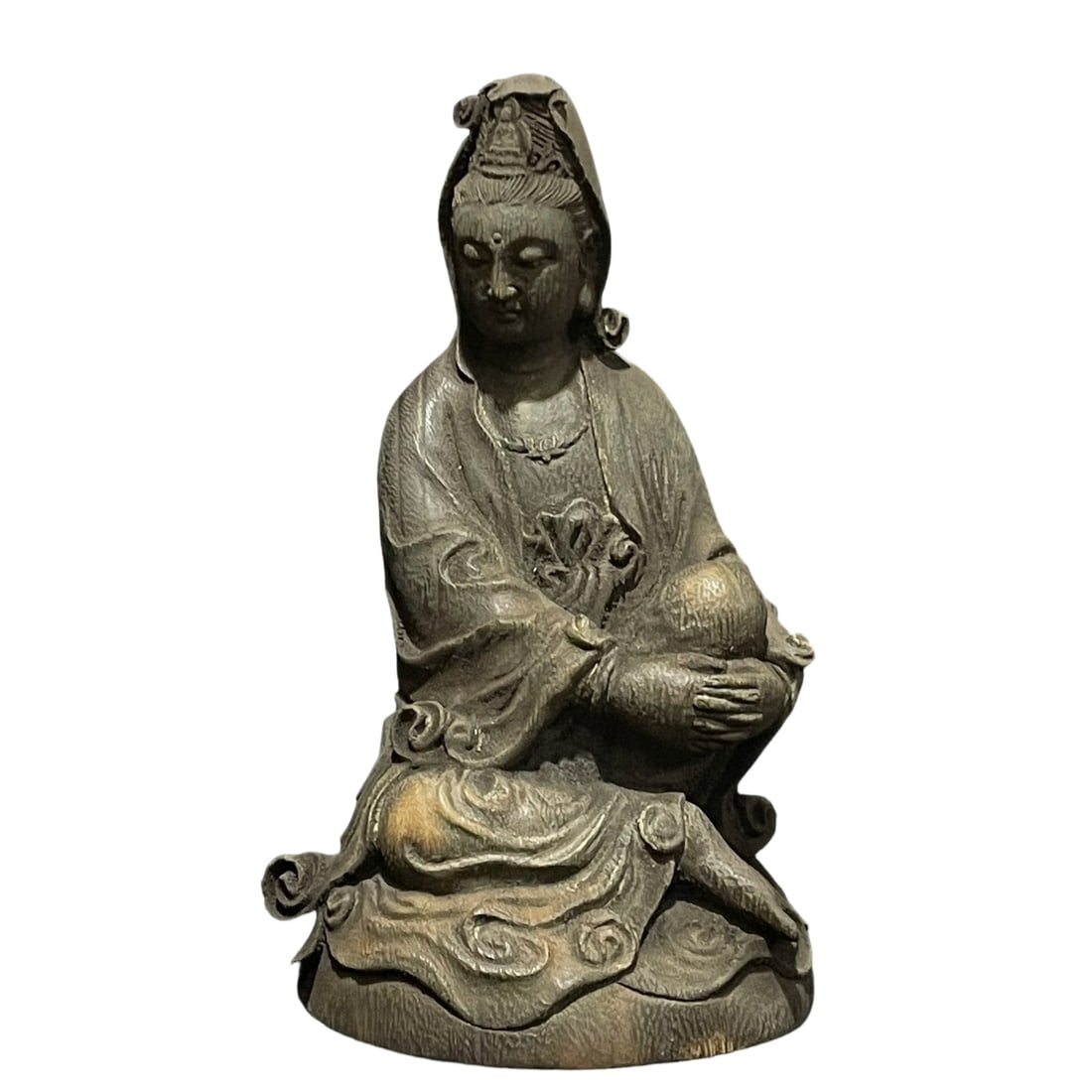 Qing Dynasty Old Agarwood Guanyin Statue: This Guanyin statue is crafted from precious old agarwood, with clear grain patterns. The Guanyin's face is full, eyes slightly open, holding a scroll. The attire is layered orderly, with a graceful