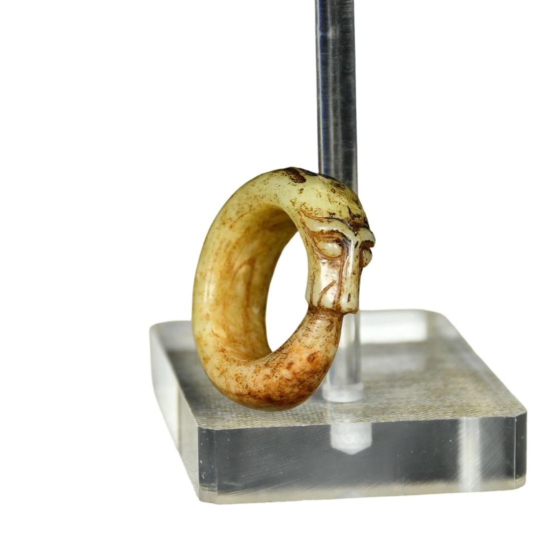 Hetian Jade Dragon Ring: This Hetian jade dragon ring is crafted in the classic 'beast head holding ring' style. The jade is of a bluish-white hue with extensive earth and reddish-brown patina, known in the industry as old ea