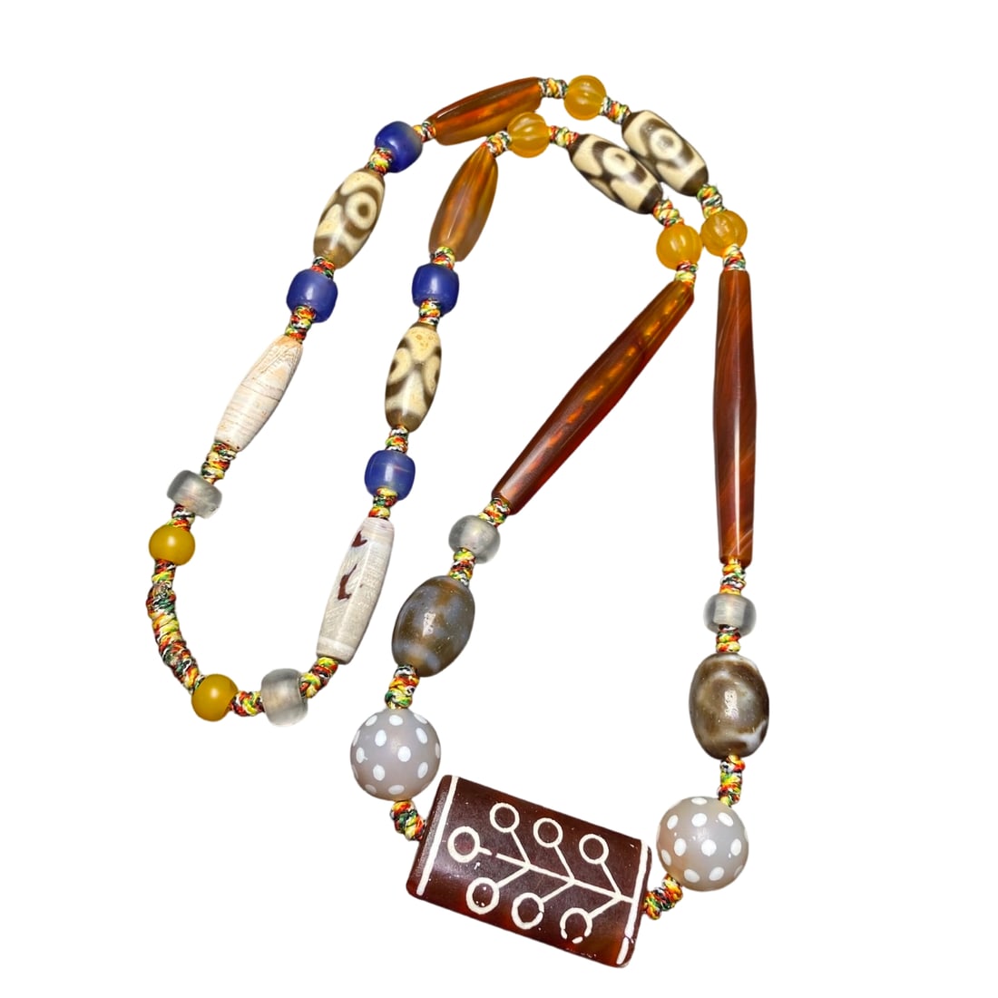 Old Dzi Bead Necklace: Antique Dzi Bead Necklace Size: Minimum 8x6mm, Maximum 68x9mm; Amulet 40x21x7mm Dzi beads have a simple appearance but profound meaning. Their rich history and beautiful legends imbue them with a weal