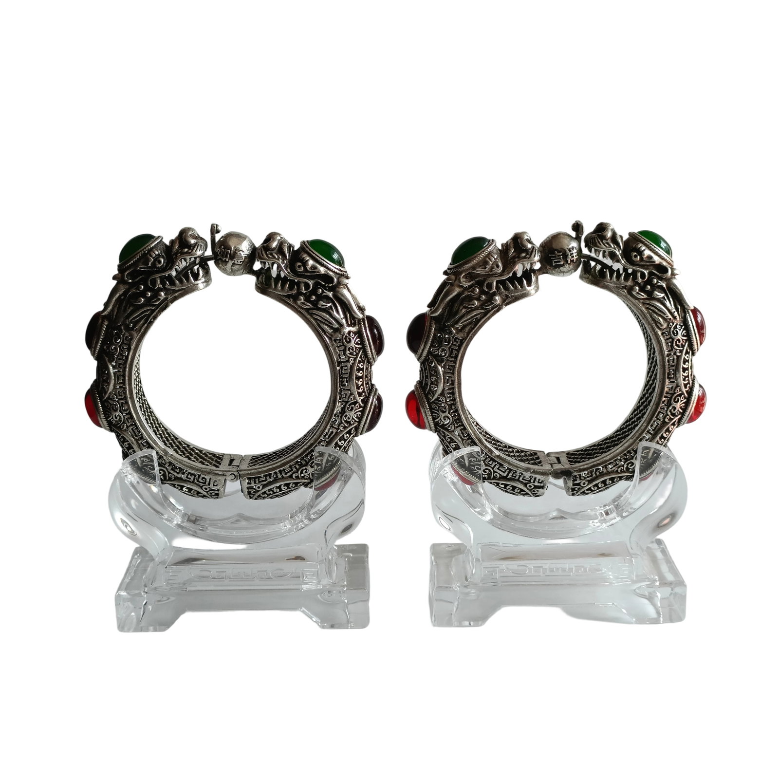 Qing Dynasty Filigree Silver Bracelets with Double Dragons and Gemstones: These bracelets are crafted with exquisite filigree work, showcasing the superb craftsmanship of Qing Dynasty silverware. The design of double dragons playing with a pearl symbolizes auspiciousness, w