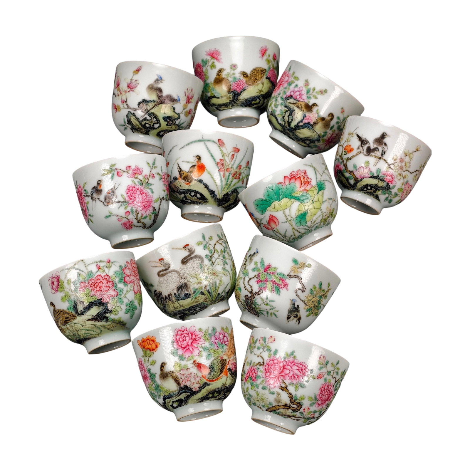 Qing Dynasty Famille Rose Twelve Month Flower God Cups: A set of twelve monthly flower goddess cups, made during the Yongzheng reign of the Qing Dynasty. Individual dimensions: 8cm wide, 9.5cm deep. The cups have a constricted mouth, an arched belly that t