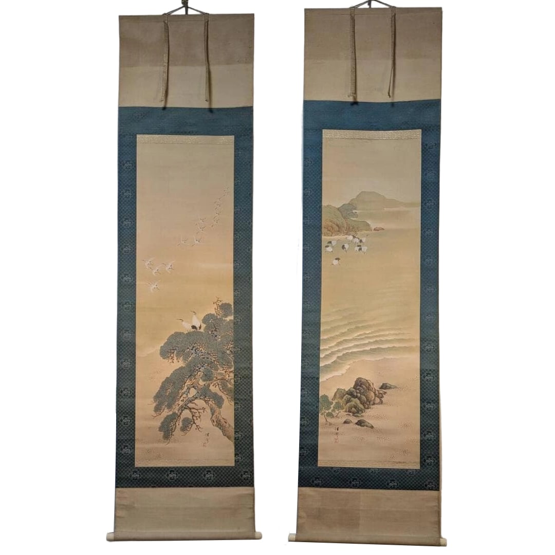 Authentic Hanging Scrolls: Pair of Crane Paintings - "Pine Tree Flight" and "Flock of Cranes by the: Mounting dimensions (including roller ends) approximately 54 x 186 cm; paper dimensions approximately 35 x 113 cm.