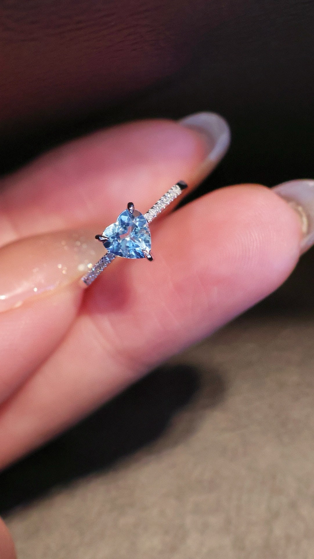 18K Natural Aquamarine Ring: This ring features a deep heart-shaped aquamarine as the main stone, showcasing a romantic and enchanting aura. The diamond-set band adds a touch of luxurious elegance, making it truly captivating. (M