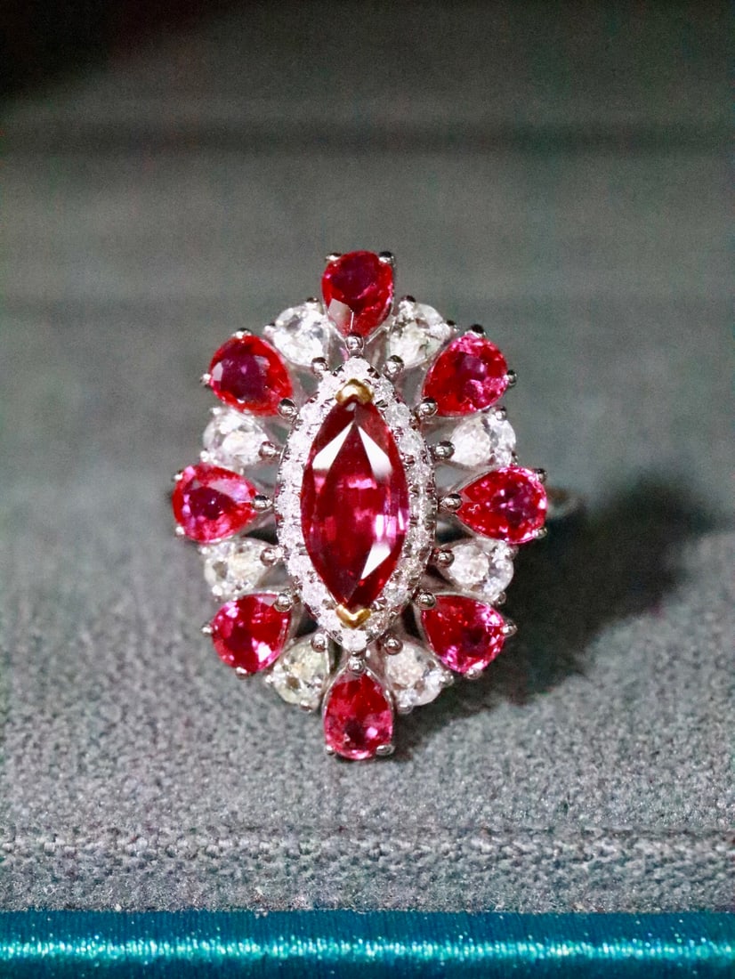 18K Natural Unheated Ruby Ring: This ruby ring showcases elegance and exquisite design, reflecting layers of artistry. Each ruby is full-bodied, rich, and vibrant, captivating the heart. (Total weight 4.47g, main stone 0.76ct, diamo
