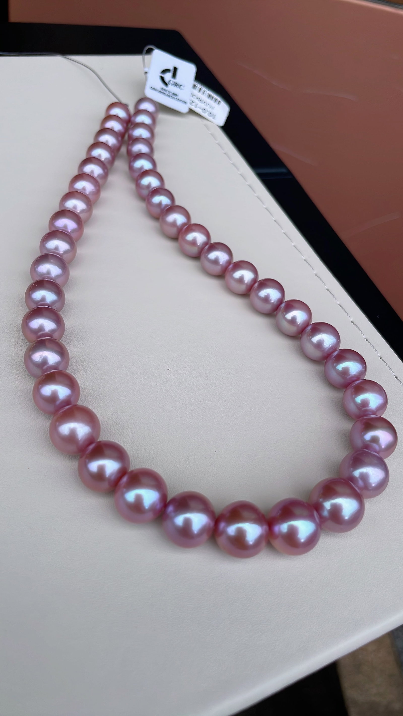 Natural Edison Pearl Necklace: This natural Edison pearl necklace showcases a unique purple luster, with pearls measuring between 10 to 12mm, nearly round, featuring a smooth and delicate surface with brilliant luster. It can be