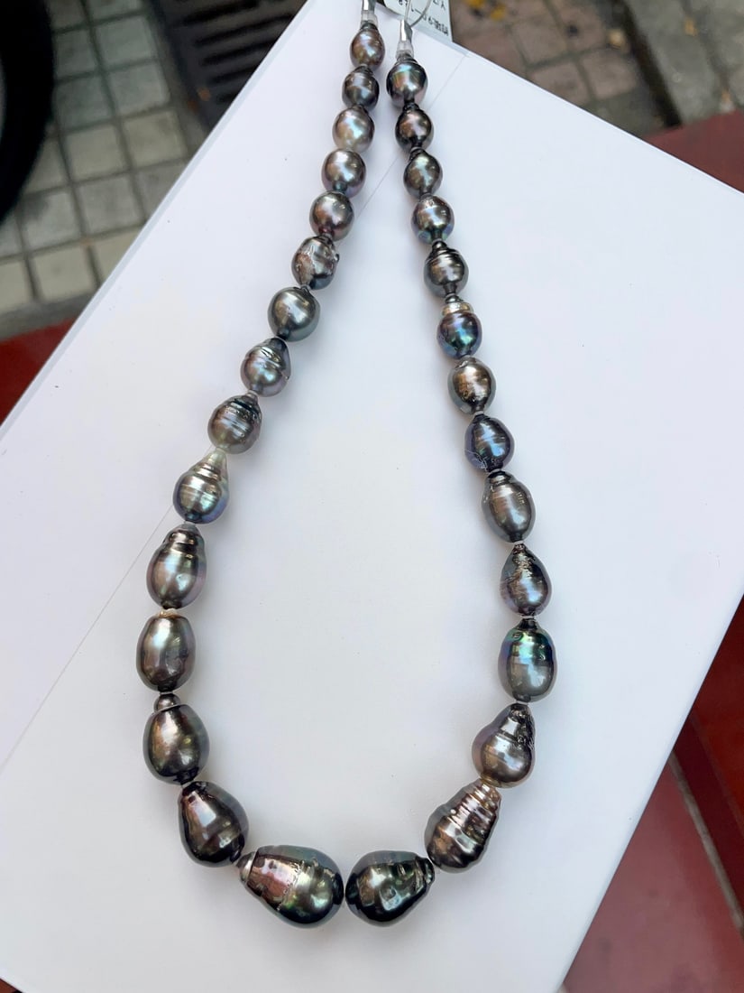 Black Pearl Necklace: This colorful black pearl necklace showcases a perfect blend of fashion and luxury with its unique black hue. Each pearl measures between 9 to 12.8 mm in diameter, and the teardrop shape design