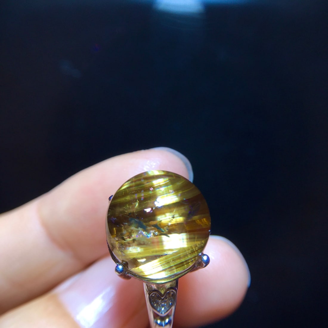 925 Silver Natural Titanium Crystal Round Bead Ring: This ring is meticulously set with natural titanium crystal in 925 silver, featuring a transparent crystal that showcases a unique cat's eye effect, symbolizing wealth and good fortune. The bare