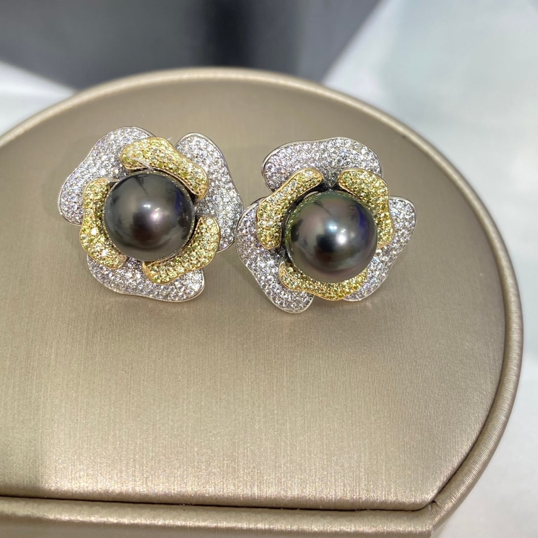 925 Silver Natural Black Pearl Earrings: These earrings are intricately set in 925 sterling silver, showcasing the unique charm of Tahitian black pearls. Each pearl measures between 10-11mm, with a flawless front that radiates brilliance, an
