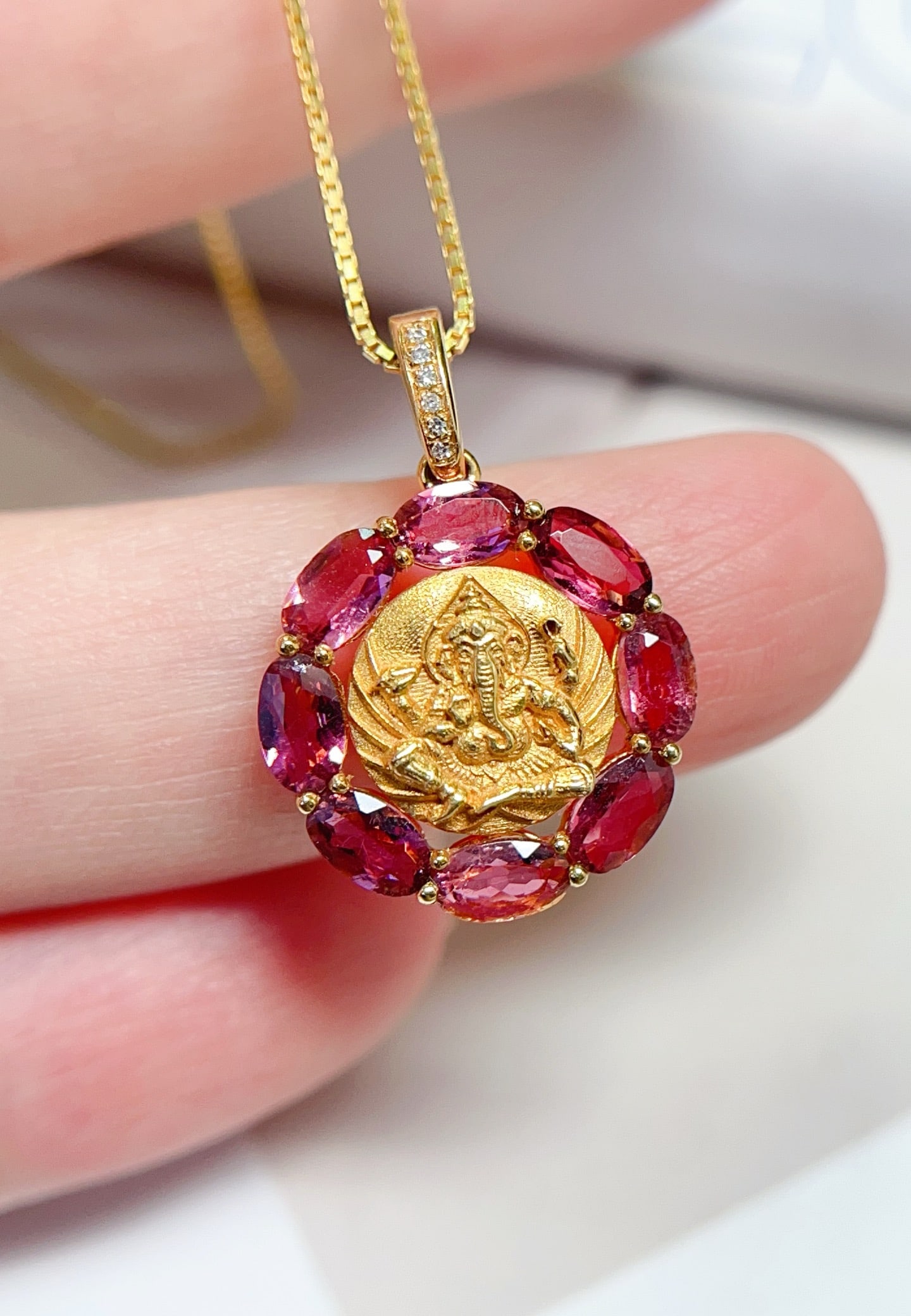 18K Gold Natural Pink Tourmaline Pendant: This pendant is meticulously crafted in 18K gold, featuring a natural pink tourmaline of approximately 1.55 carats, showcasing its unique hue and luster. Surrounded by six brilliant diamonds, the over