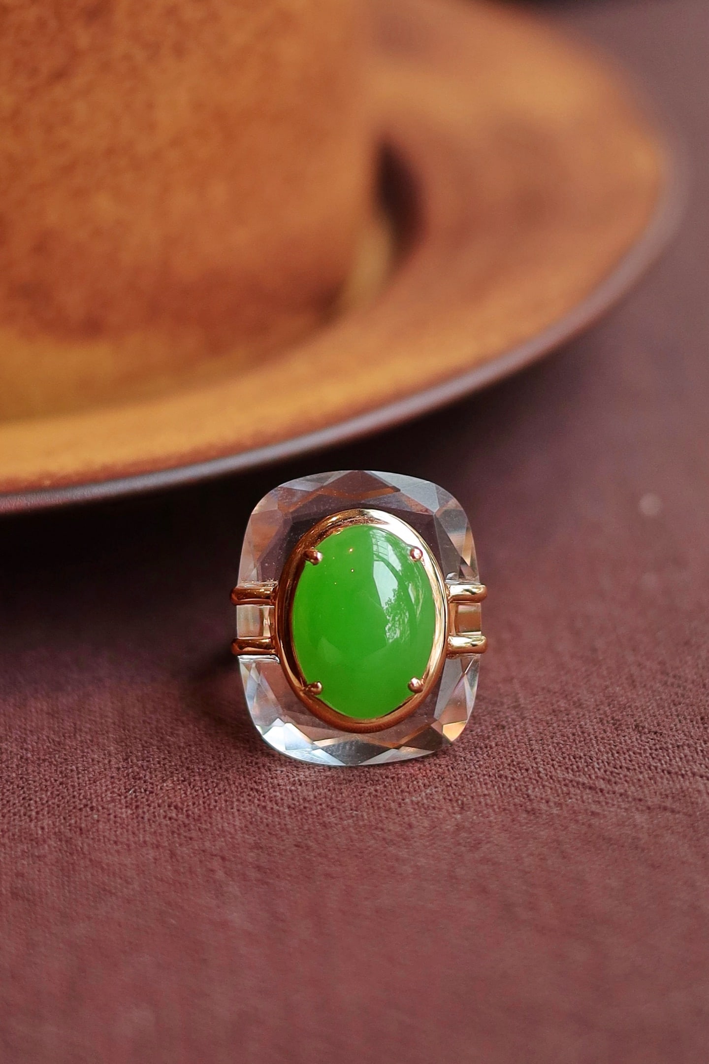 18K Gold Jade Apple Green Crystal Ring: This ring is intricately set in 18K gold, featuring a jade apple green crystal cabochon with rich and even green hues, and a fine, warm jade texture. The 5A grade white crystal's three-dimensional set
