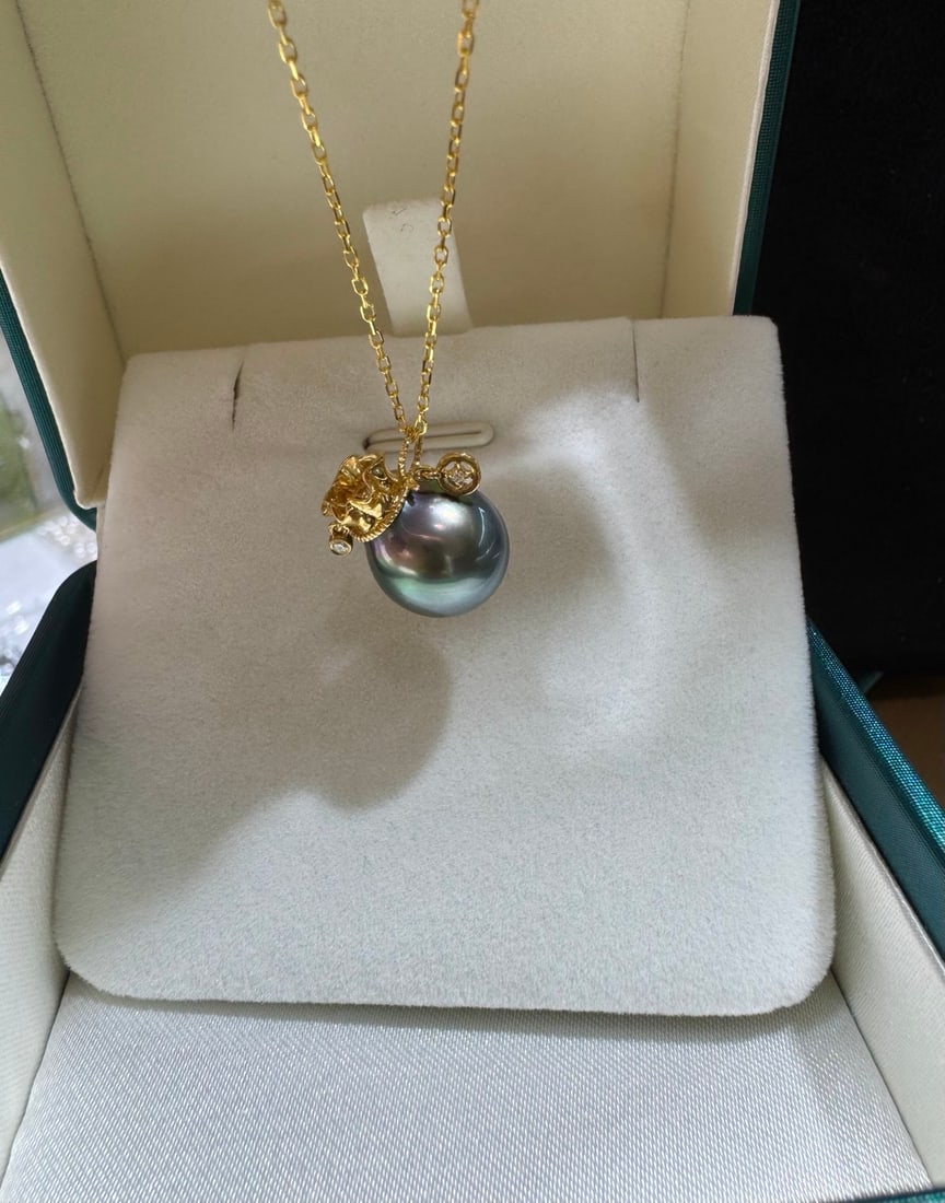 18K Gold Tahitian Black Pearl Pendant: This pendant is meticulously crafted in 18K gold, set with diamonds, showcasing the natural allure of the Tahitian black pearl. The pearl diameter is 11-12mm, featuring a near-round shape and strong